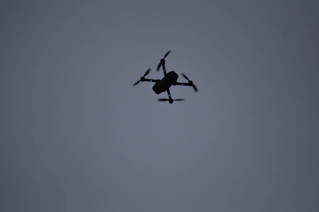 High-tech military drone flying over a dark, stormy sky symbolizing advanced aerial defense.