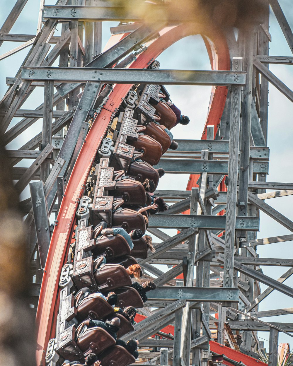 people riding on roller coaster during daytime