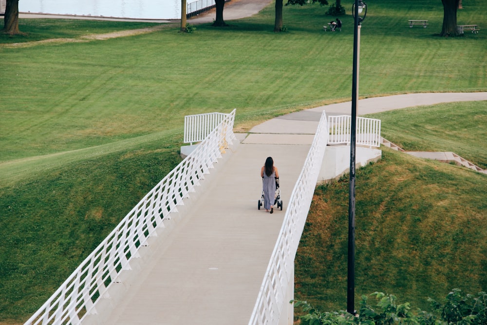 2 people walking on pathway during daytime