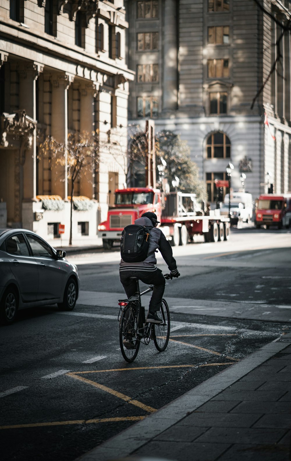 man in black jacket riding bicycle on road during daytime