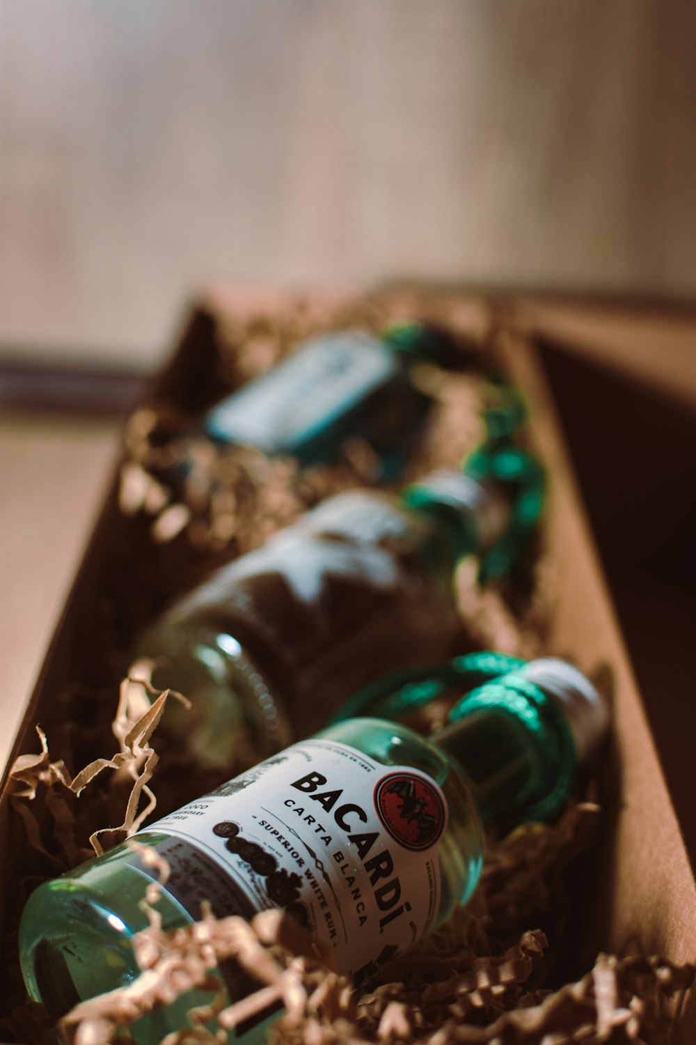 green glass bottle on brown wooden table