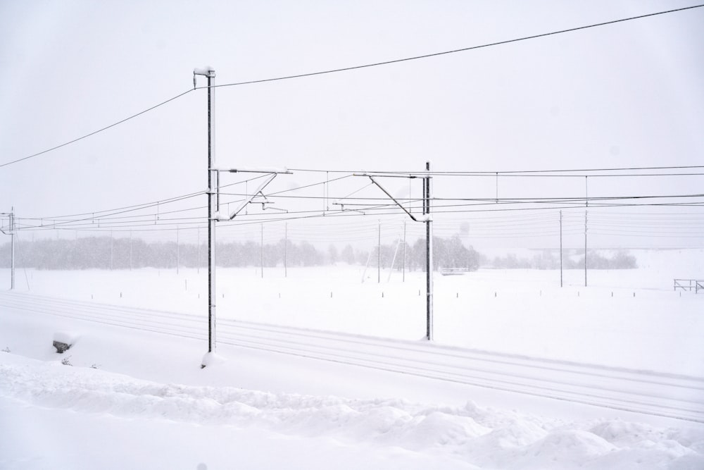 black electric post on snow covered ground