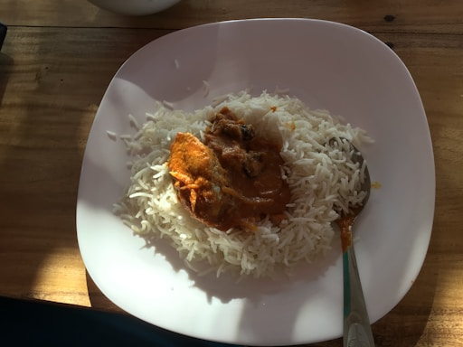An appetizing plate of fish curry served with rice.