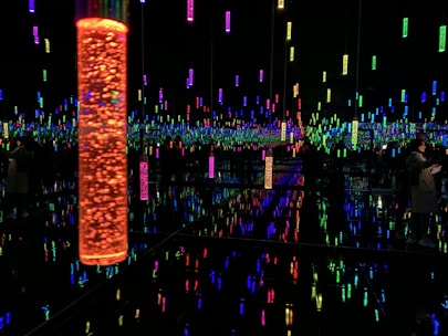 A sleek, futuristic light installation glowing with shifting colors in a modern room.