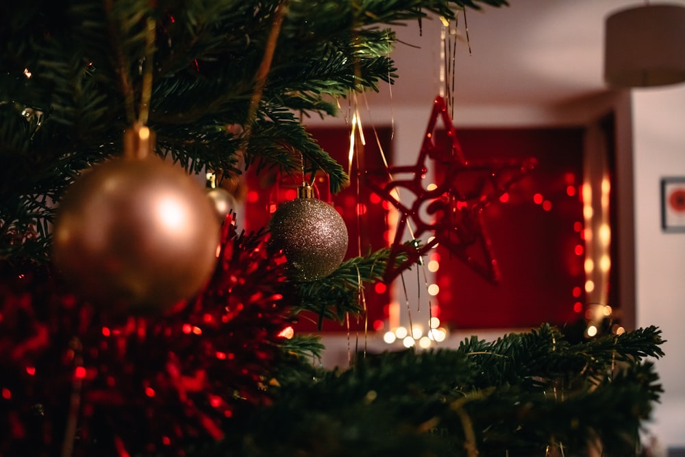 gold baubles on green christmas tree