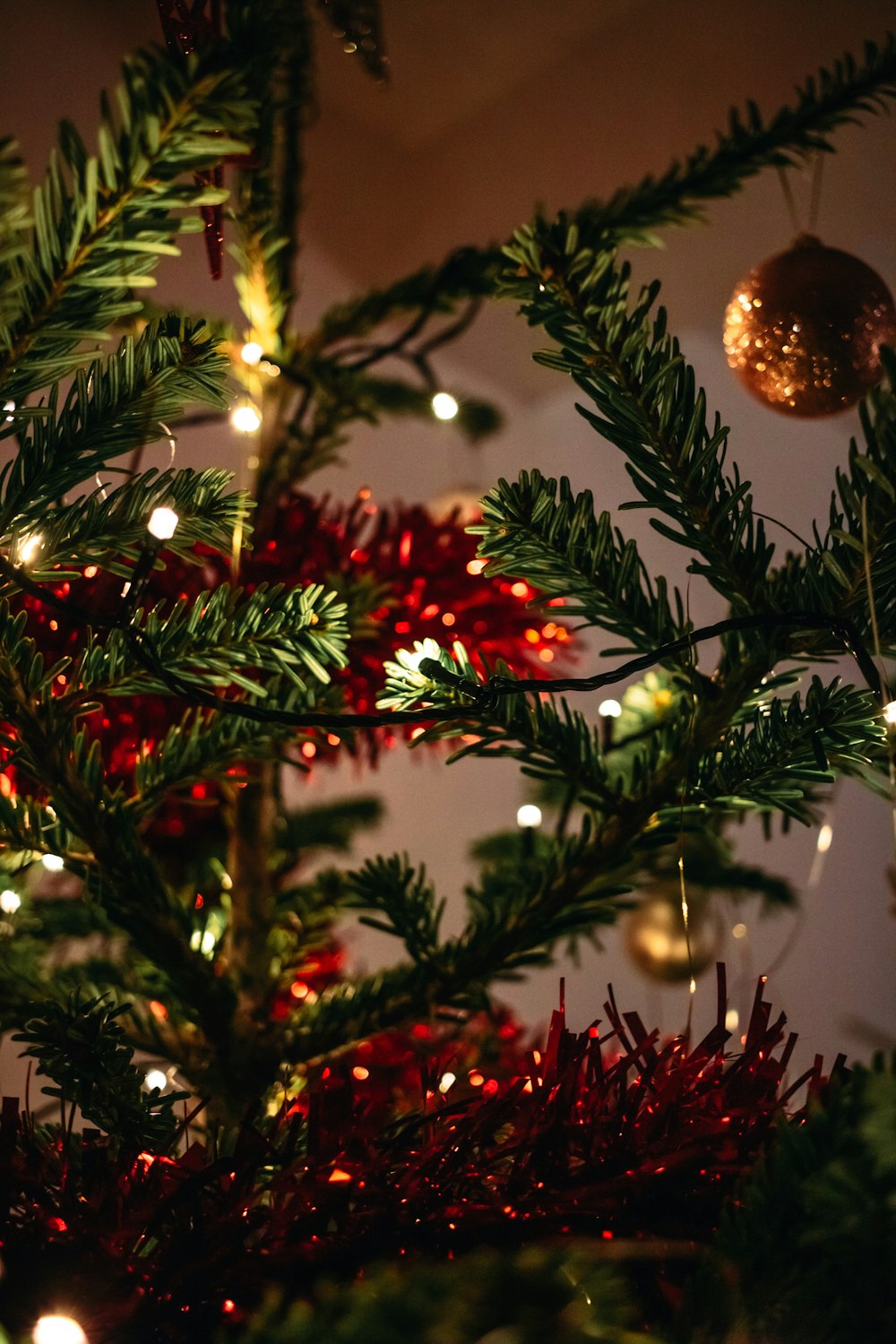 red and gold baubles on green christmas tree