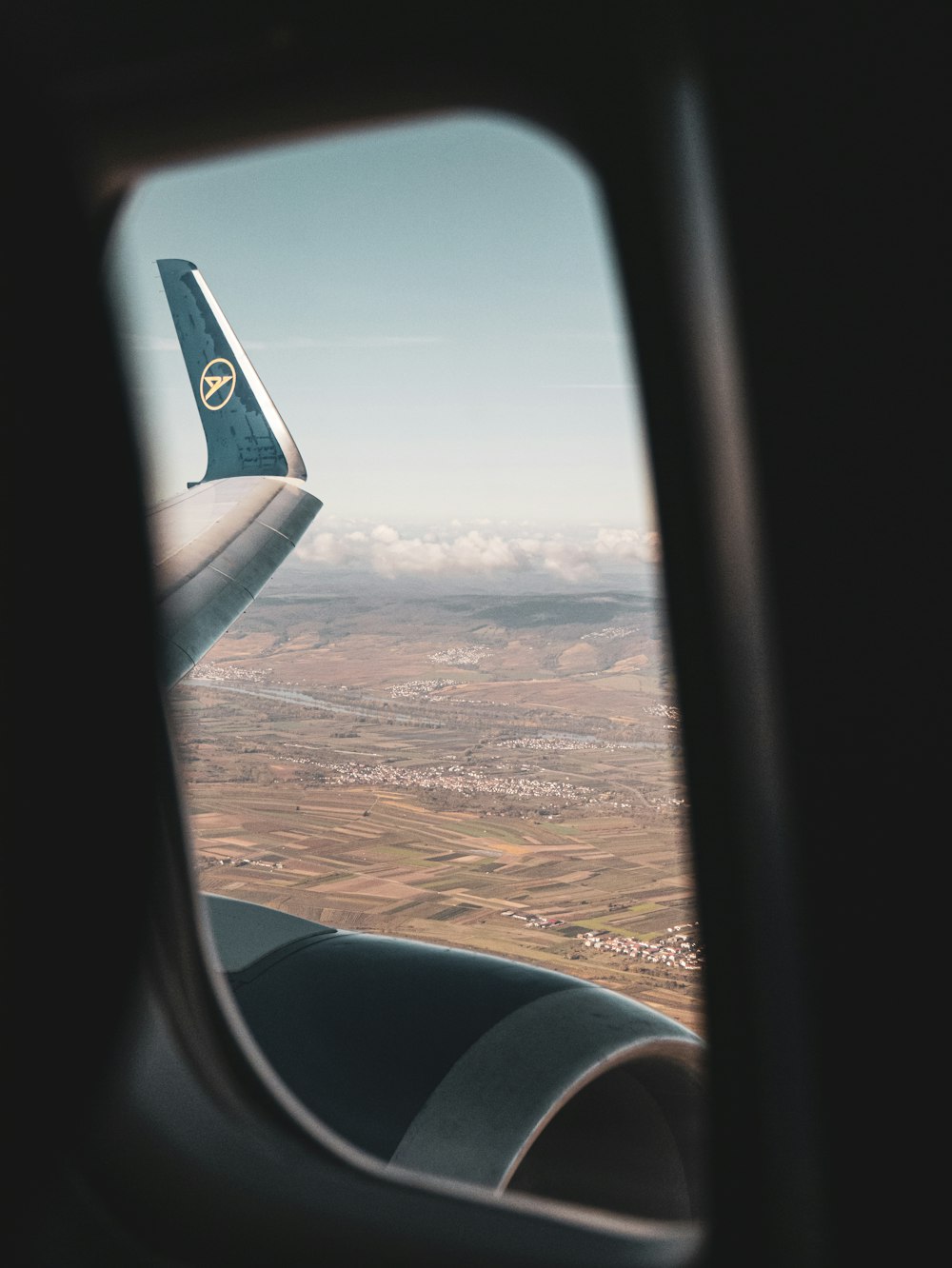 airplane window view of clouds during daytime