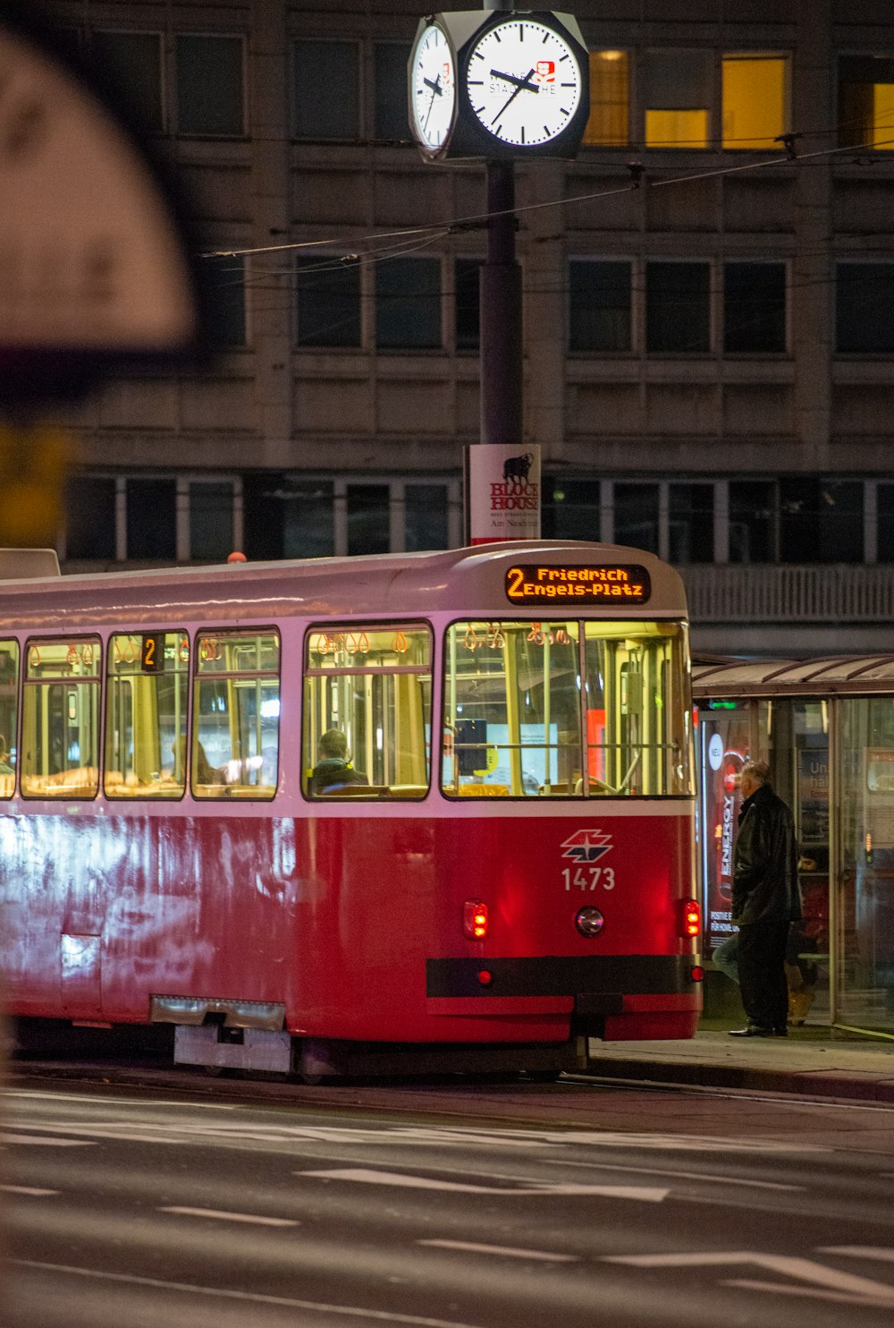 red and white tram on the city during daytime