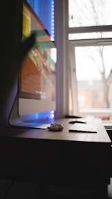black computer mouse on brown wooden table