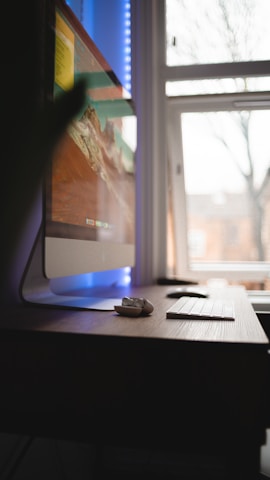 black computer mouse on brown wooden table