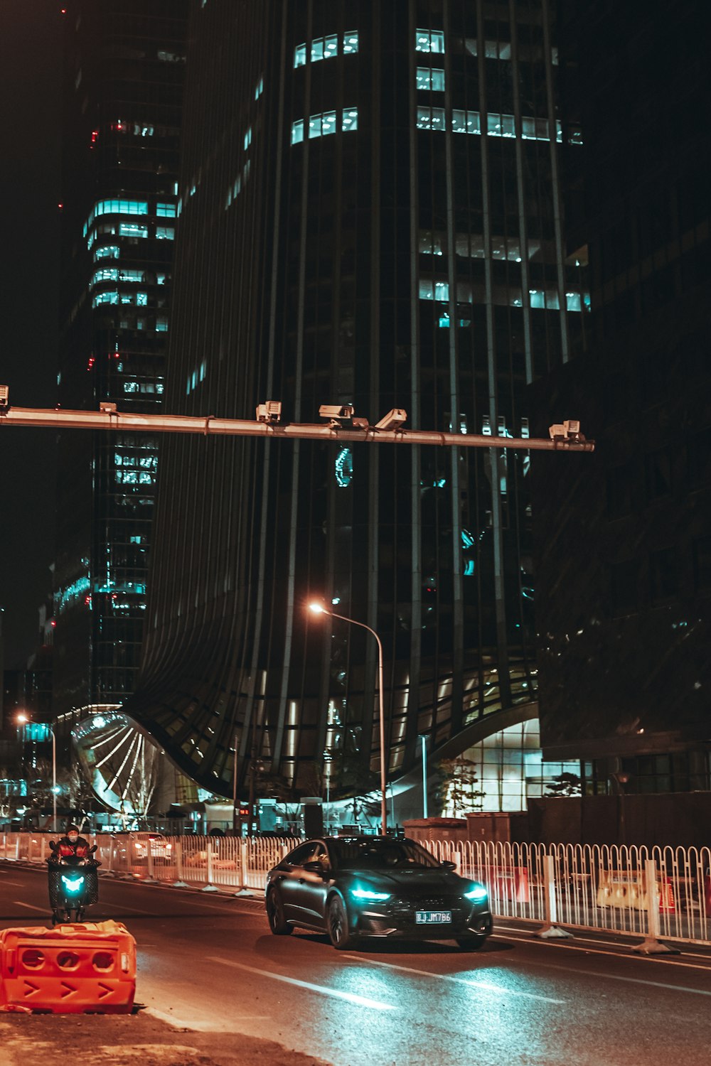 cars on road near high rise buildings during night time