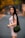 woman in white long sleeve shirt holding green sling bag