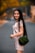 woman in white long sleeve shirt holding green sling bag