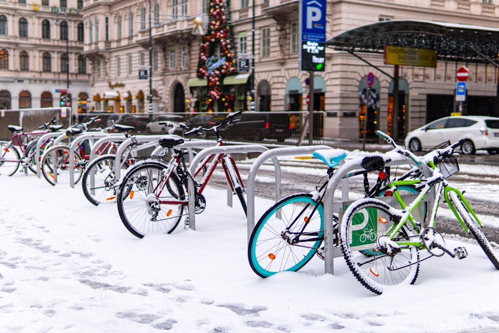blue and green bicycles on snow covered ground during daytime