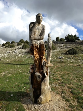 Ancient North and West African sculptures standing guard in a serene woodland clearing.
