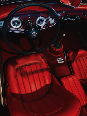 Interior dashboard and seats of a car restored to spotless condition with rich textures.