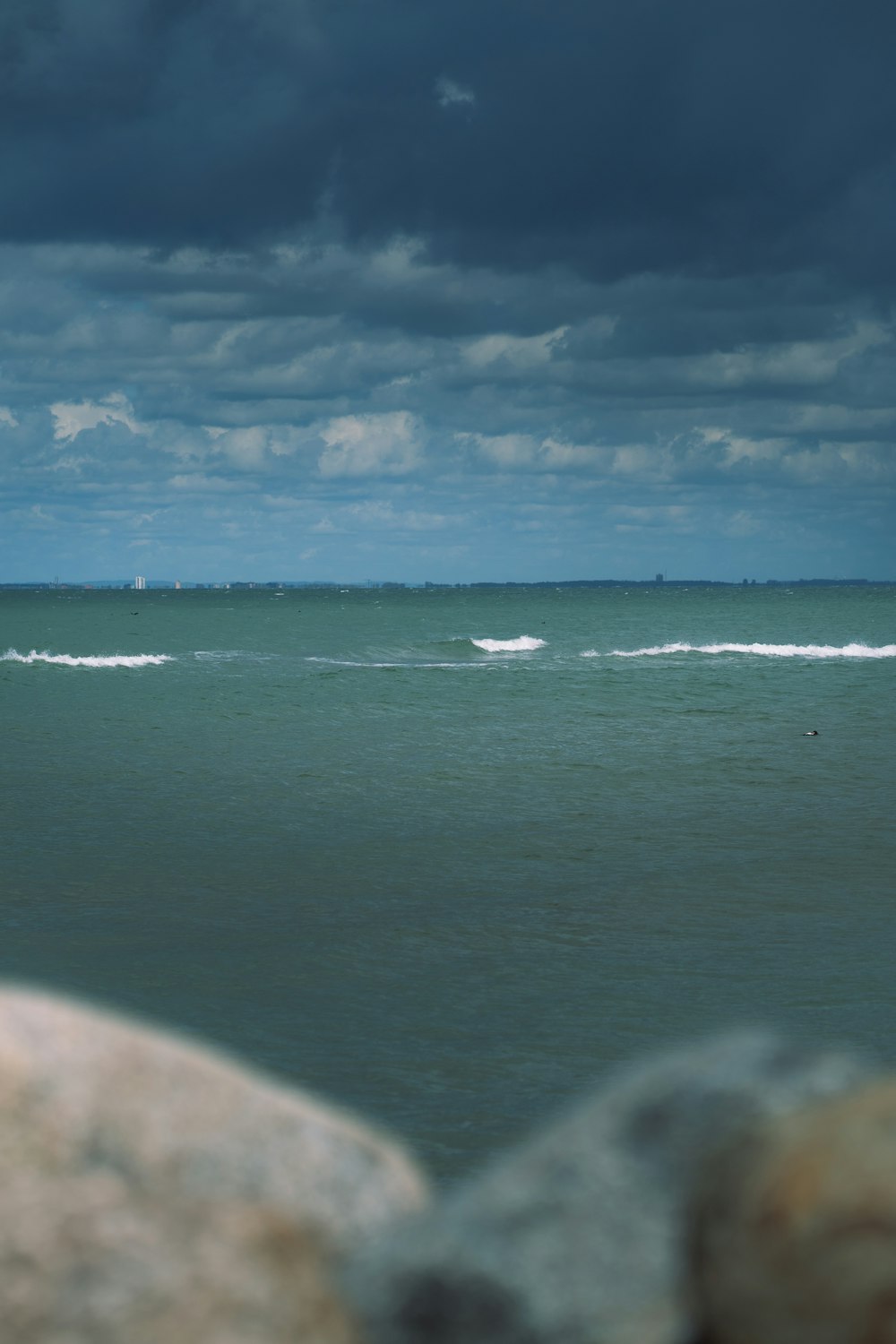 blue sea under blue sky and white clouds during daytime