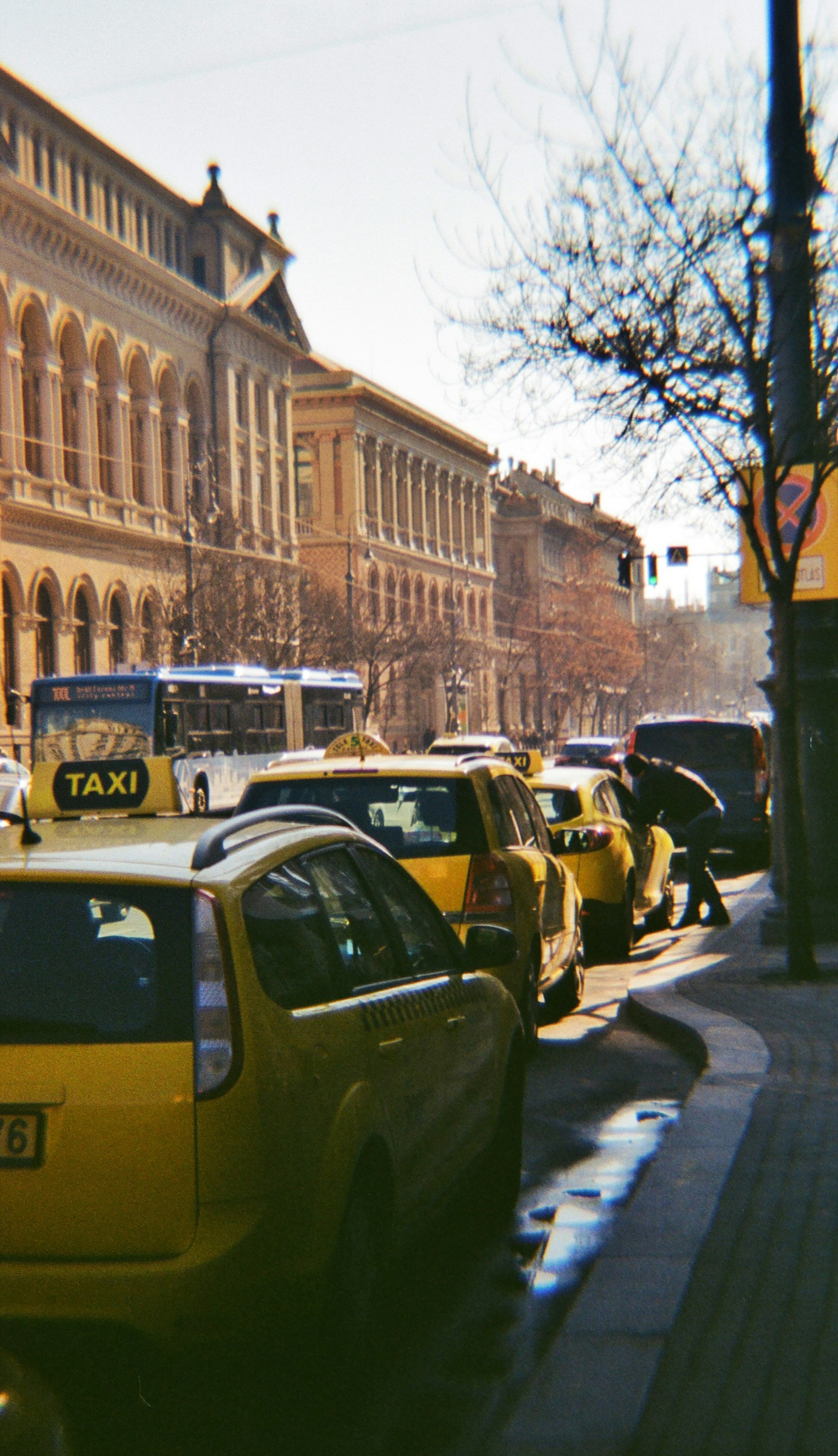 cars parked on side of the road near building during daytime