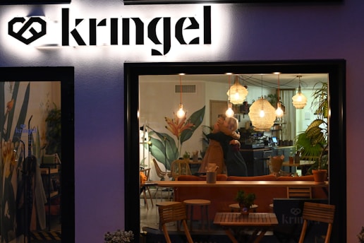 A warm, inviting coffee shop scene where a couple is sharing a genuine smile during their first date.