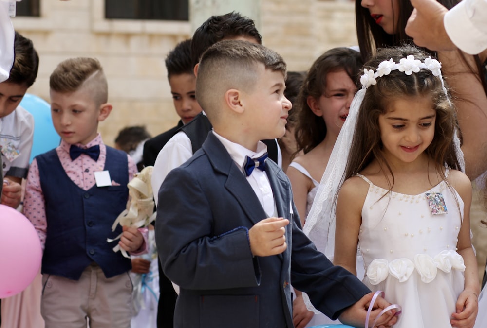 man in blue suit jacket and woman in white wedding dress