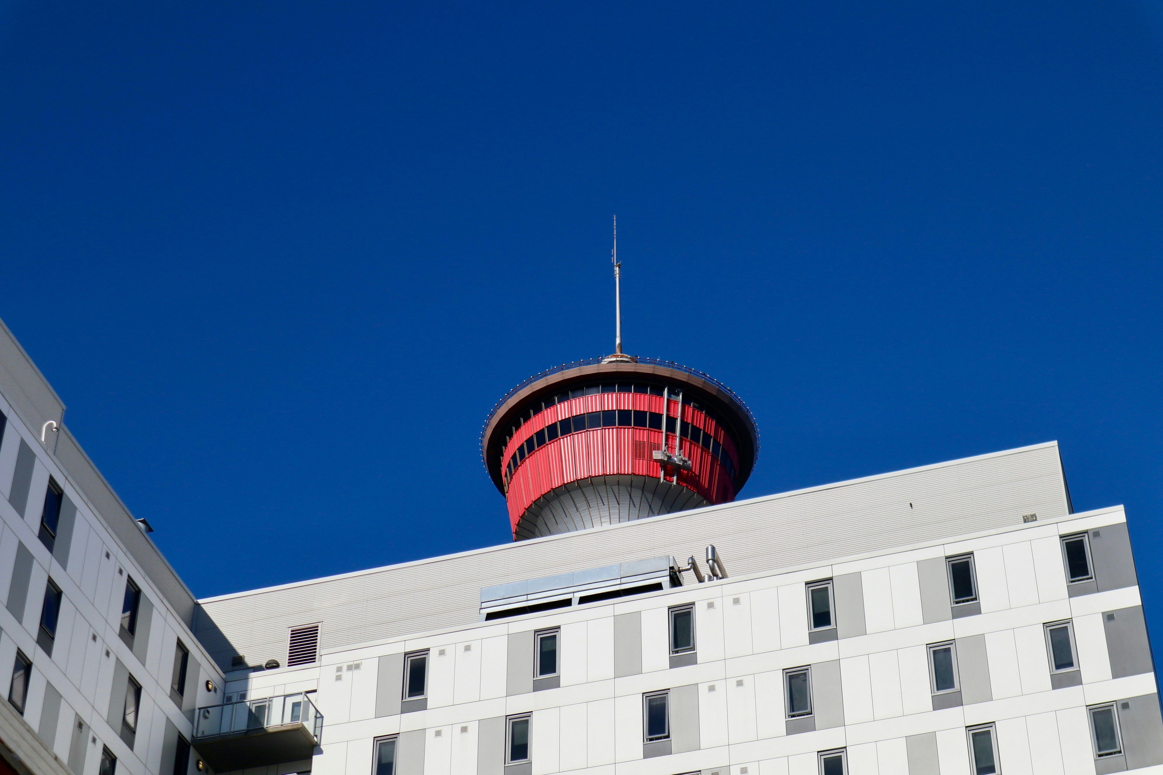 white concrete building under blue sky during daytime, Calgary Tower