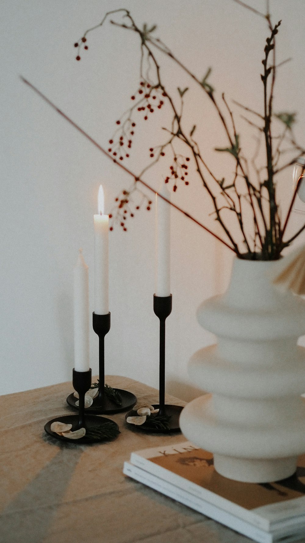 white candles on black metal candle holder