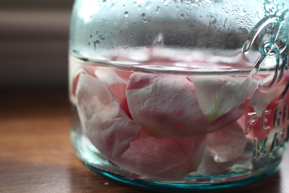 pink flower petals in clear glass jar