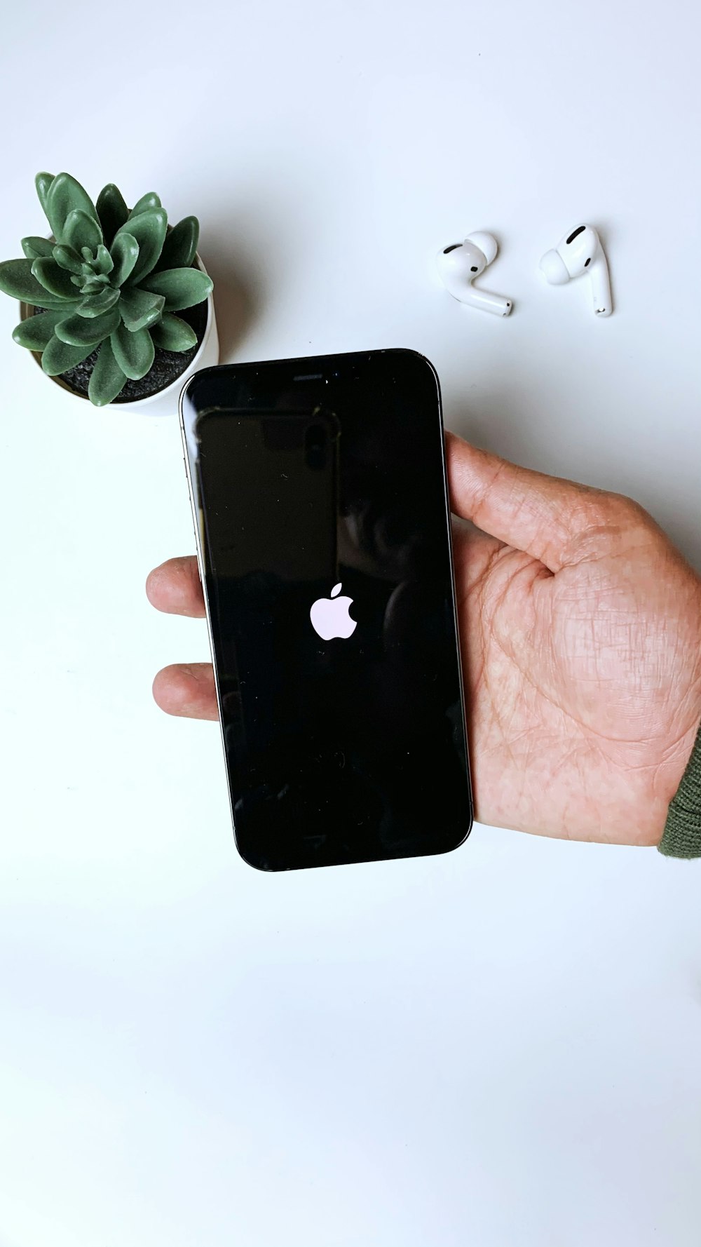 person holding black iphone 4