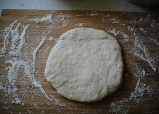 white dough on brown wooden table