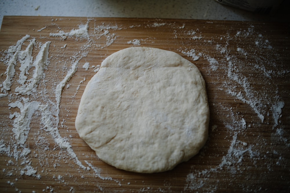 white dough on brown wooden table