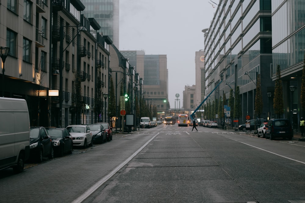 a person walking down a street next to tall buildings