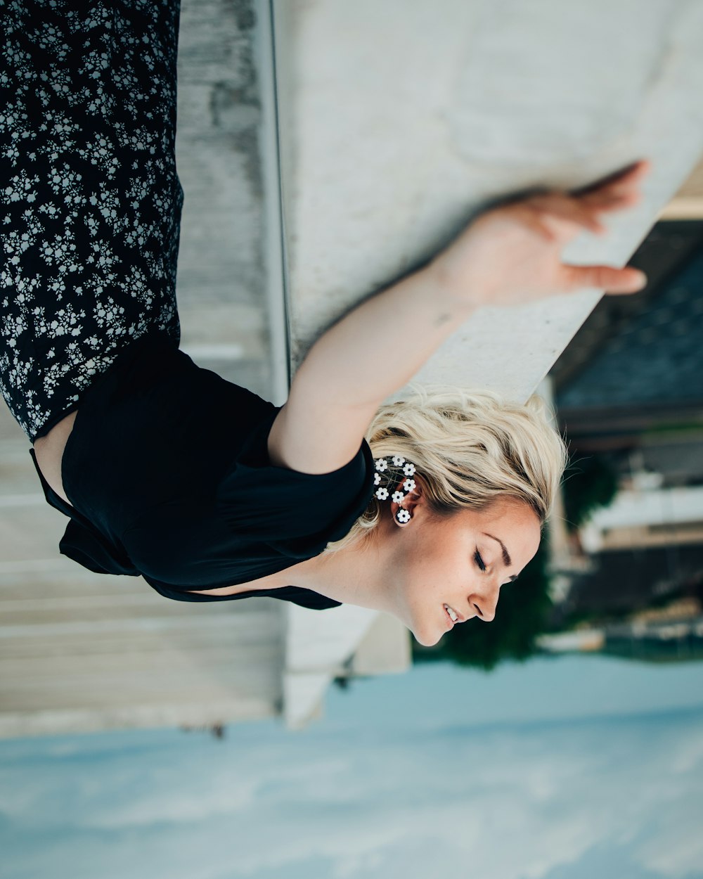 a woman in a black top is doing a trick on a skateboard