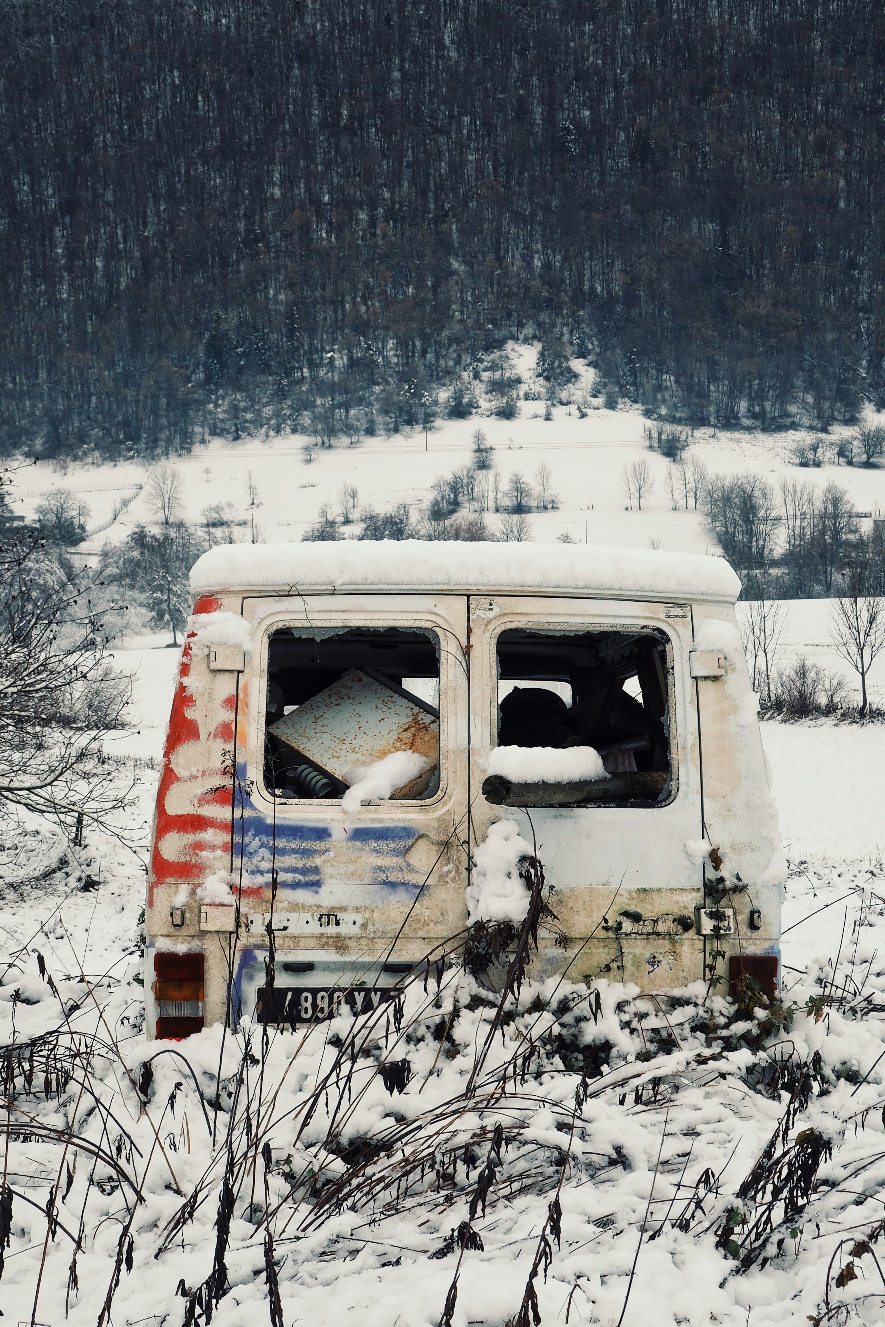 white and brown van on snow covered ground during daytime