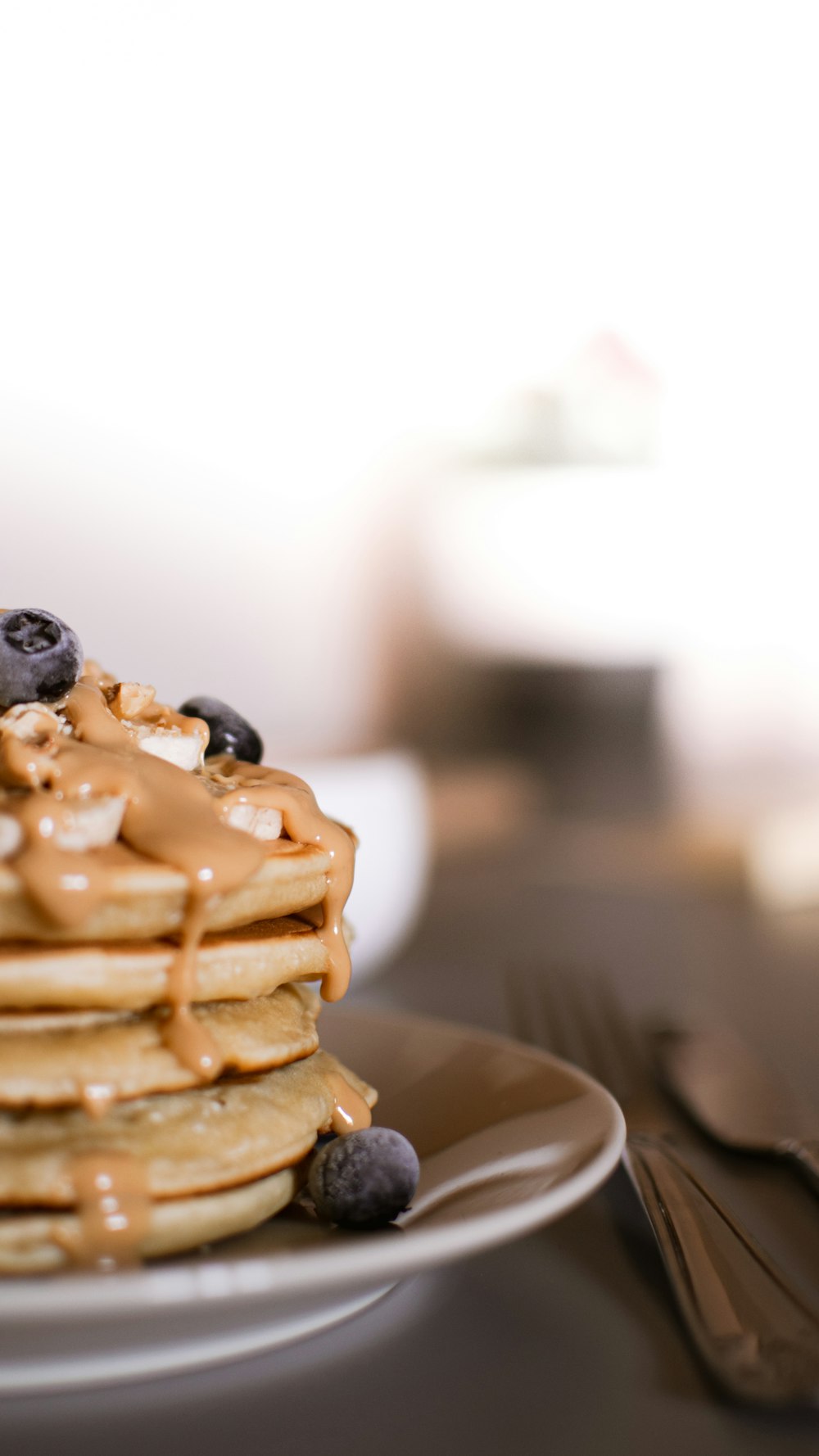 waffle with black berries on white ceramic plate