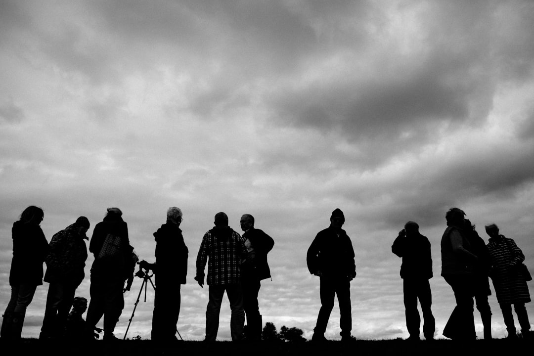 silhouette of people standing on snow covered ground