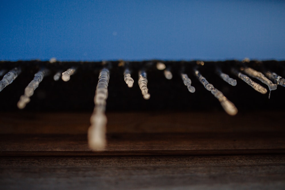 water droplets on brown wooden surface