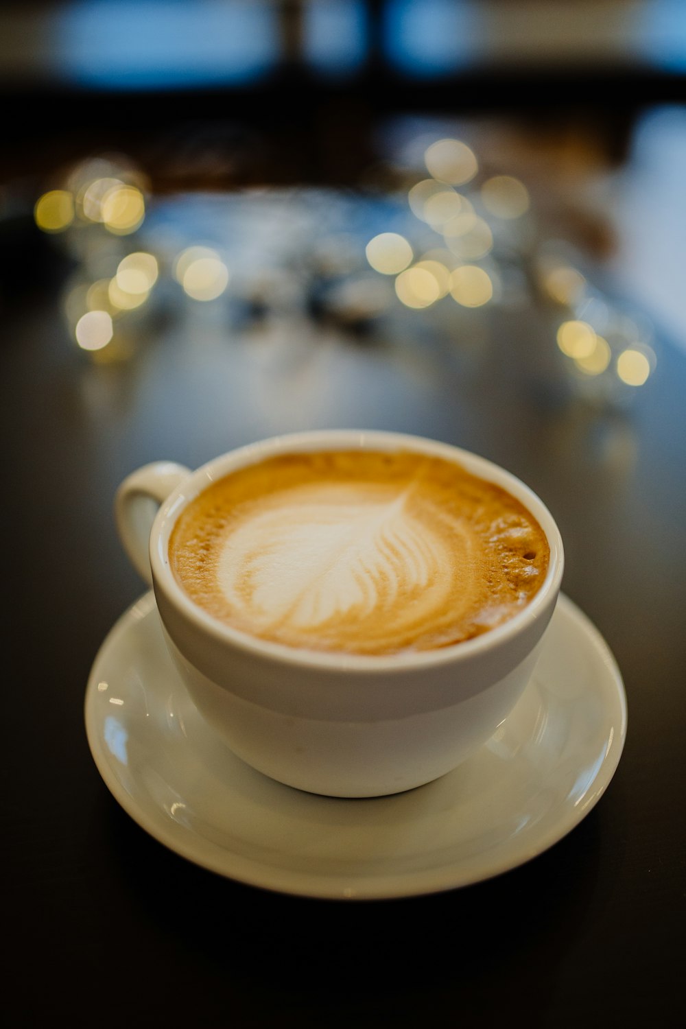 white ceramic cup with brown and white liquid