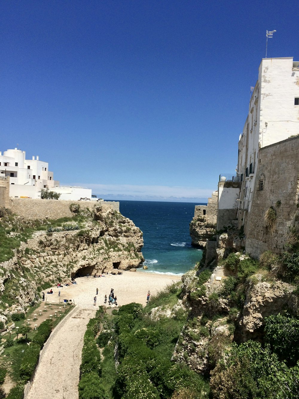 Gente caminando por la orilla de la playa durante el día