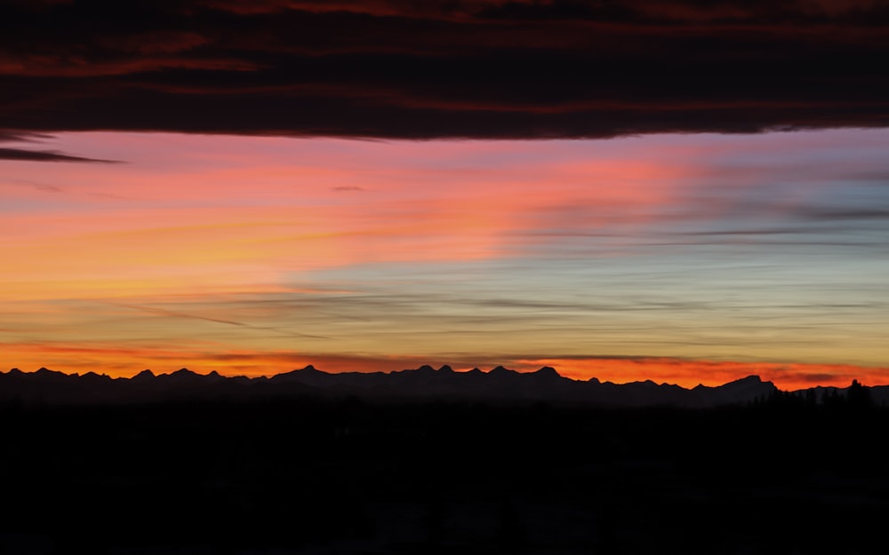 silhouette of mountains during sunset