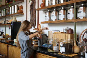 woman in white shirt holding clear glass jar