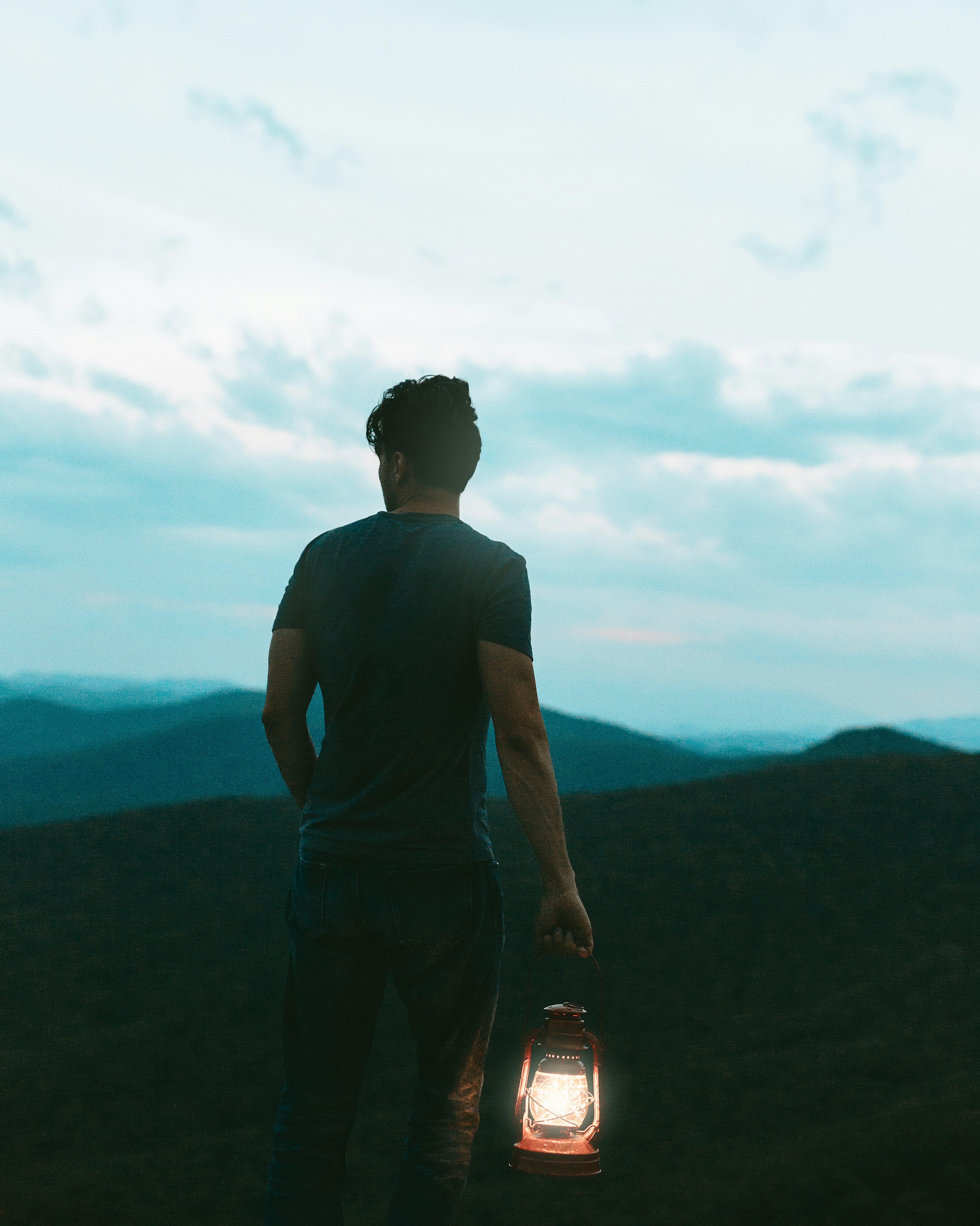 Man on top of mountain observing God's creation.
