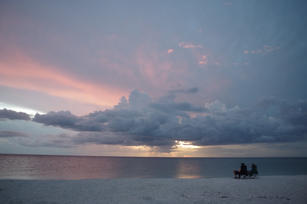 people on beach during sunset