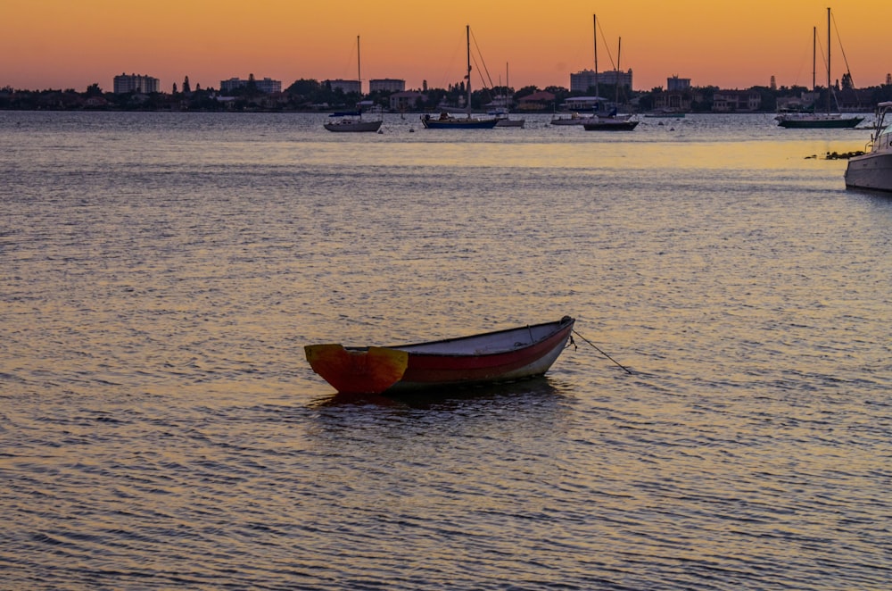 red and white boat on sea during daytime