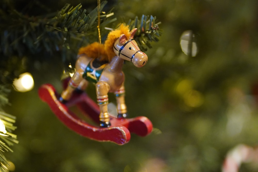 red and yellow plastic toy on green plant