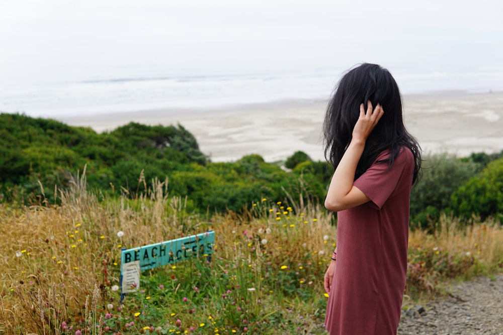 woman in red dress holding blue box