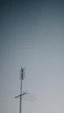Close-up of a high-quality TV antenna mounted on a rooftop against blue sky