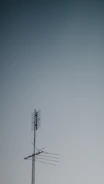 Close-up of a high-quality TV antenna mounted on a rooftop against blue sky