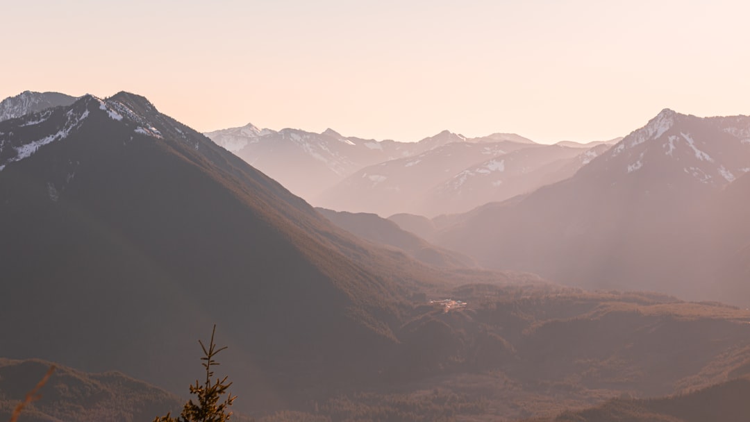 brown and green mountains under white sky during daytime