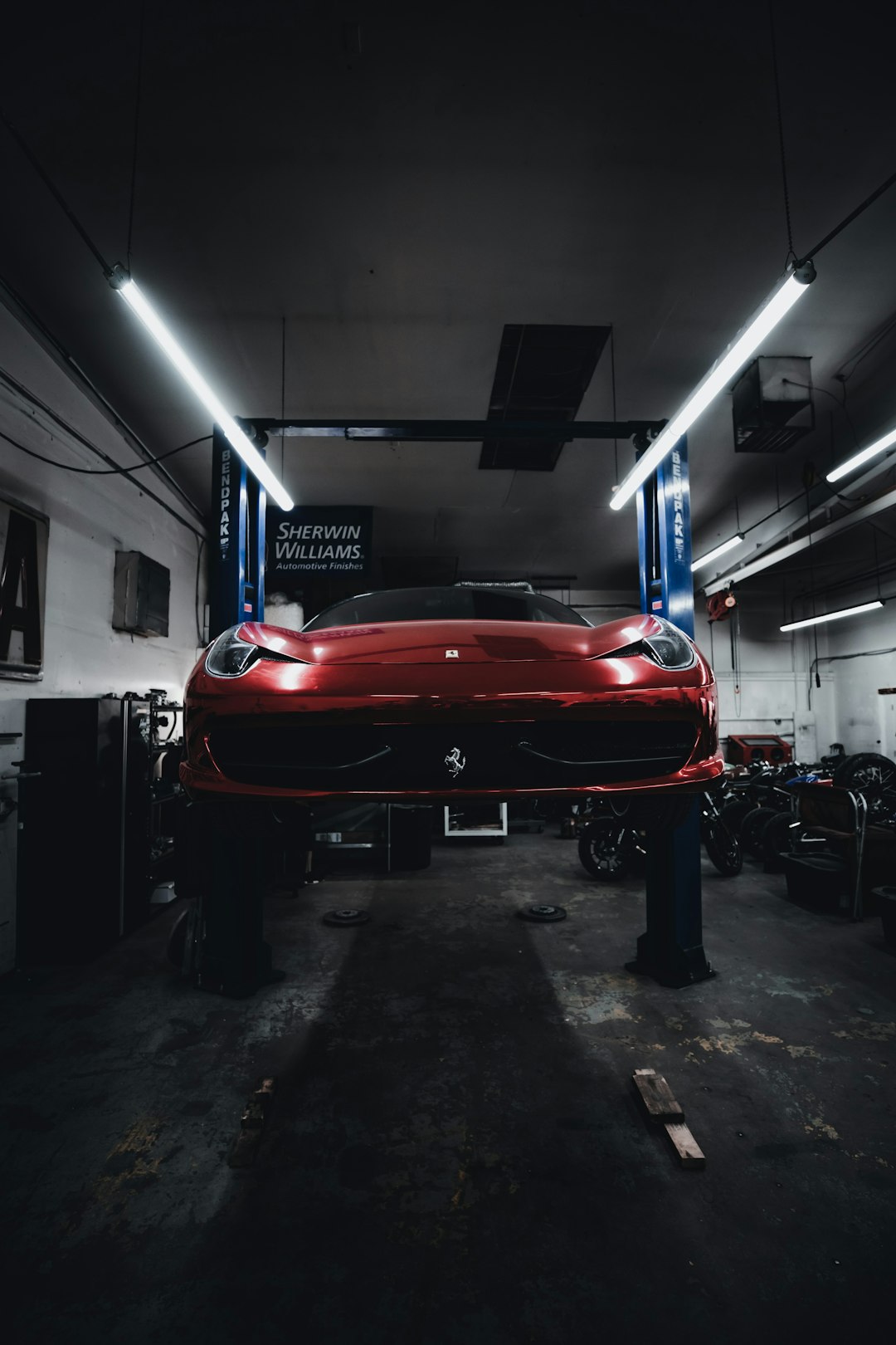 red ferrari car in a garage