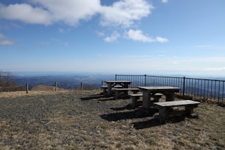 A scenic mountain view with a family picnic setup.